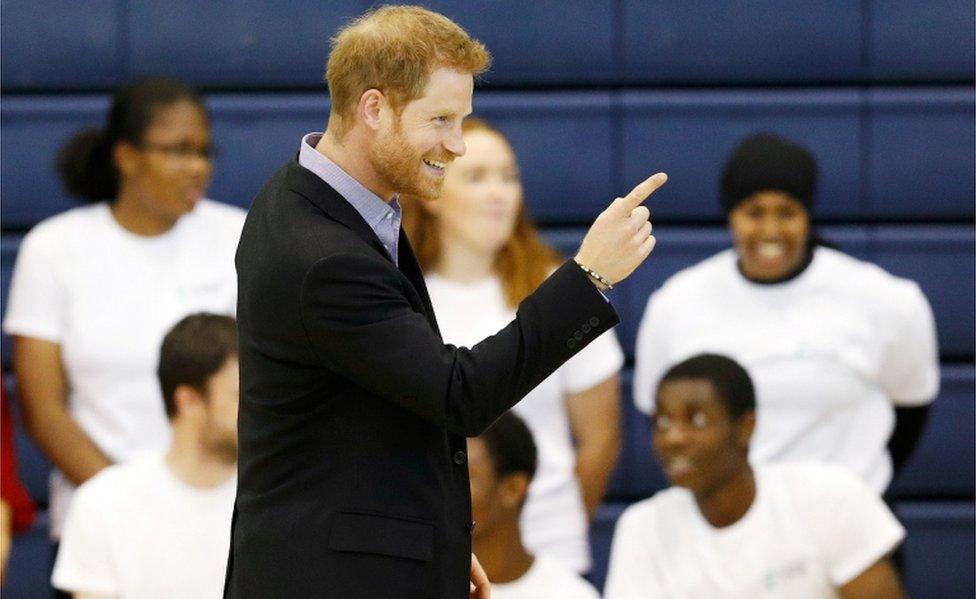 Prince Harry beams and points a finger at the Coach Core awards at Loughborough University