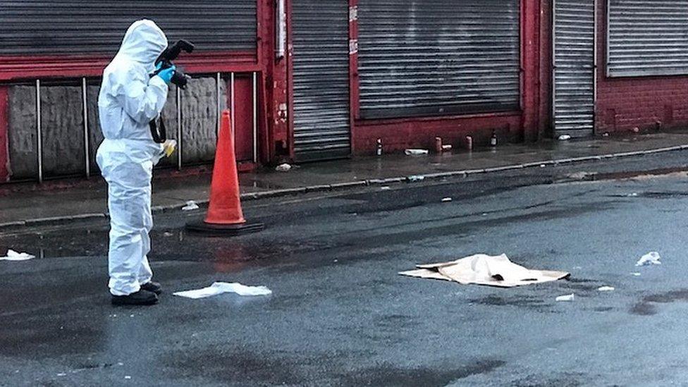 Man in forensic suit outside Anfield.