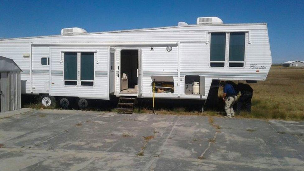 This Handout photo released by Prosecution Press Office shows investigators searching in a trailer in the ranch of US citizen Orson William Black Jr. alleged "fugitive of the American justice for sexual crimes" and leader of a sect called "La Comuna" in Cuauhtemoc, Chihuahua state, Mexico on November 5, 201