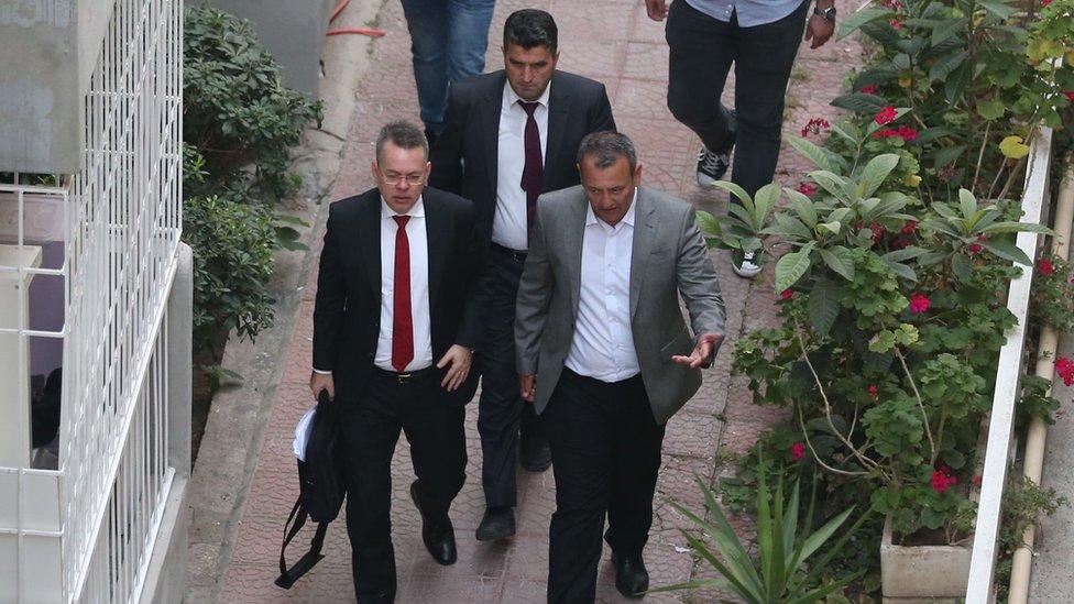 Pastor Brunson is escorted to his home in Izmir, after being freed.