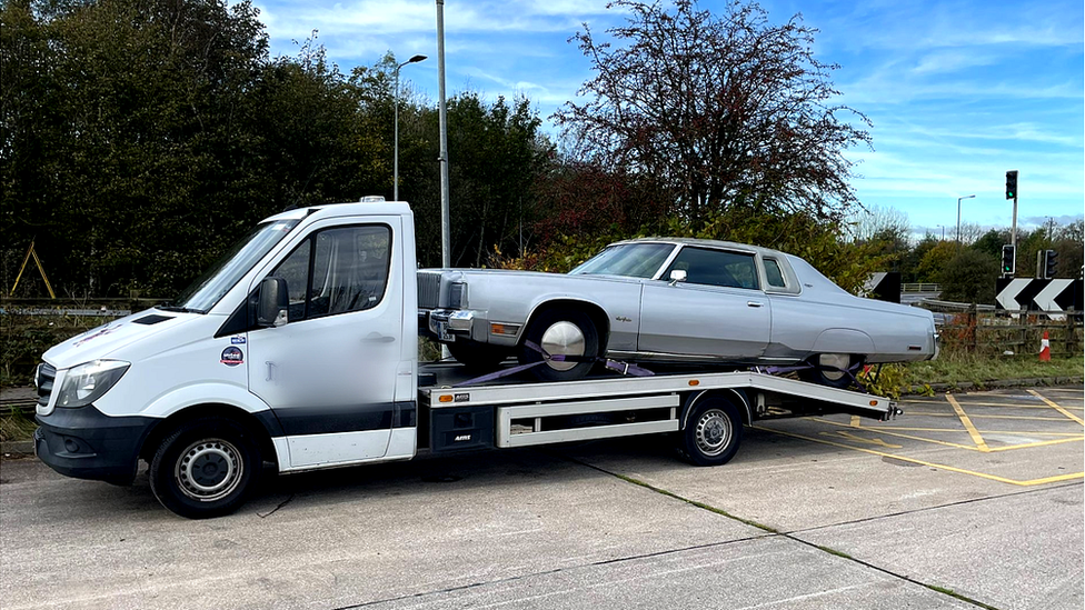 The 3.5-tonnes transporter carrying a vintage American car