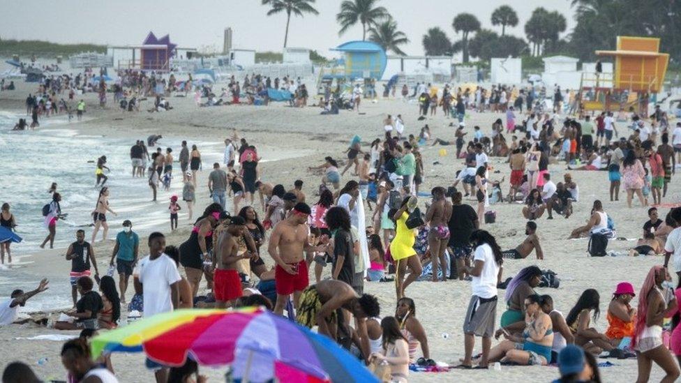 Large crowds of people gather during spring break, in Miami Beach