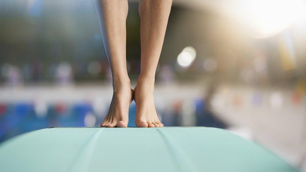 Feet on diving board - stock photo