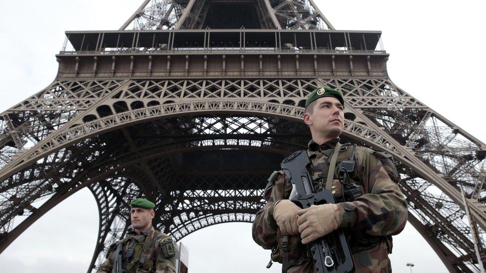 French soldiers patrol in front of the Eiffel Tower on 7 January 2015