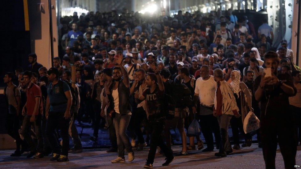 Syrian refugees disembark from a ferry at the port of Piraeus, near Athens, Greece, 01 September 2015.