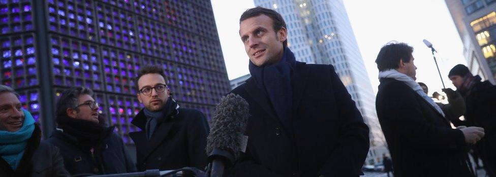 French presidential candidate Emmanuel Macron (c) talks to journalists in Berlin, on January 10, 2017