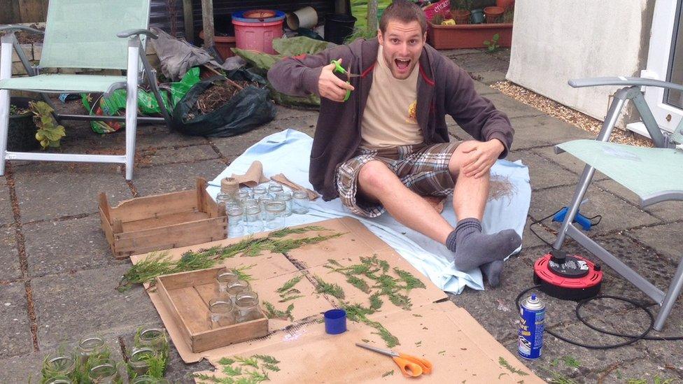 James sitting in the garden cutting up ferns to make wedding decorations