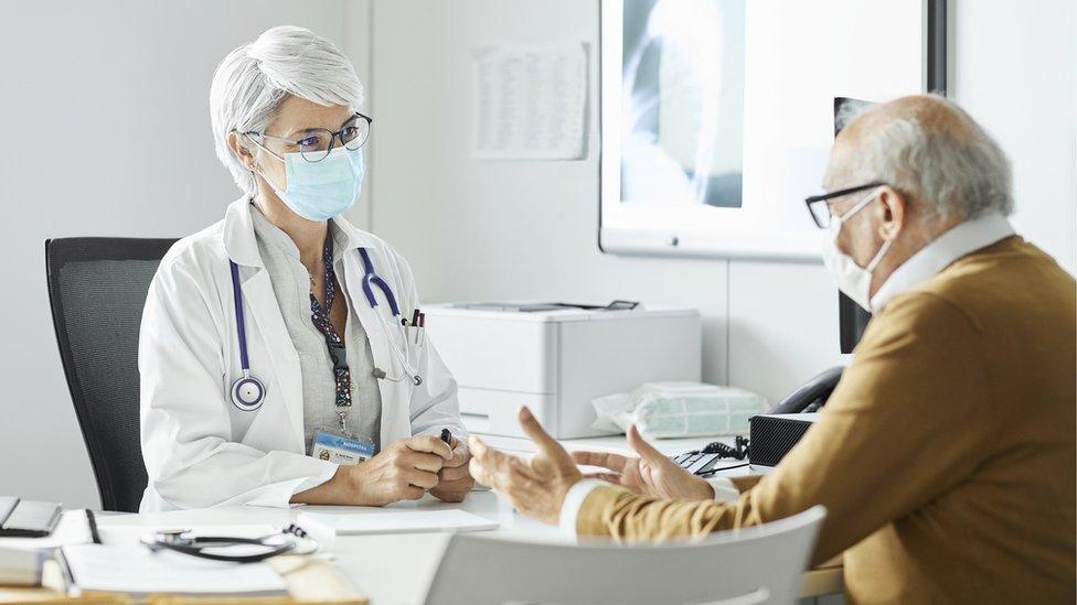 A doctor speaks to a patient