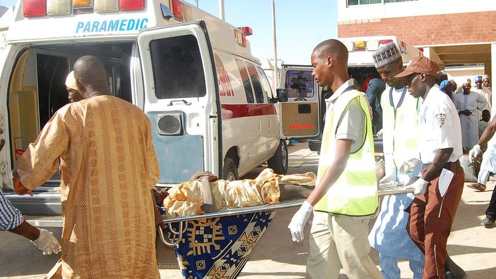 In this Wednesday, Feb. 10, 2016 file photo, rescue workers transport a victim of a suicide bomb attack at a refugee for treatment at a hospital, in Maiduguri, Nigeria.