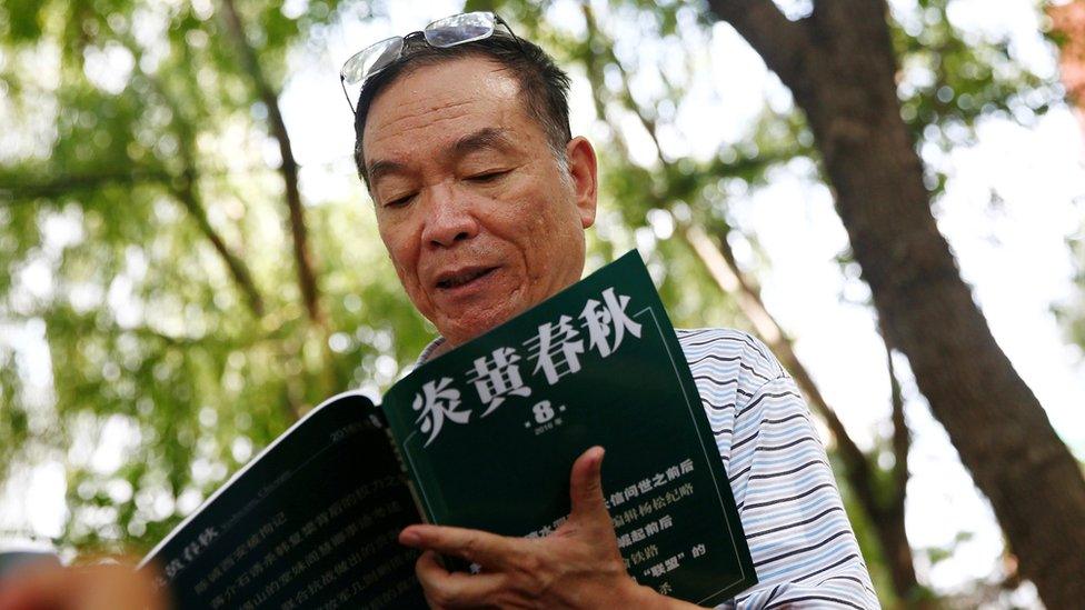 Wang Yanjun, former vice editor-in-chief of the liberal magazine Yanhuang Chunqiu, also known as China Through the Ages, holds an issue of the magazine as he speaks to the media outside the Chaoyang District Court in Beijing, China, August 16, 2016.