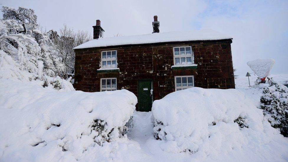 Cottage covered in snow