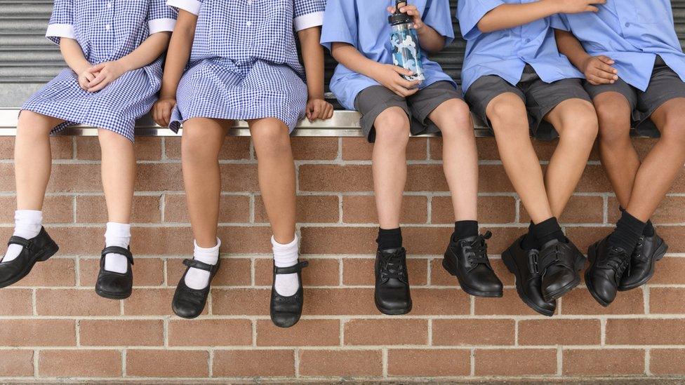 Children sitting on a wall