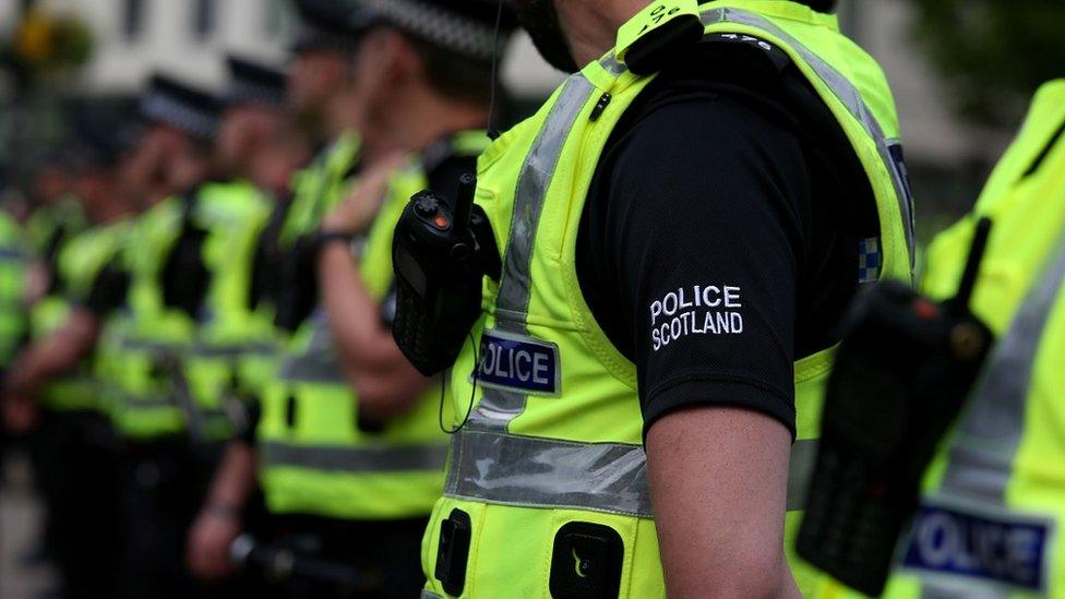 Police officers stand in a line