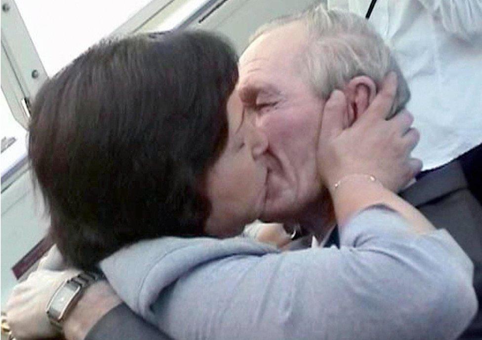 An emotional Hitomi Soga kisses her husband Charles Jenkins at Jakarta airport, on 9 July 2004.