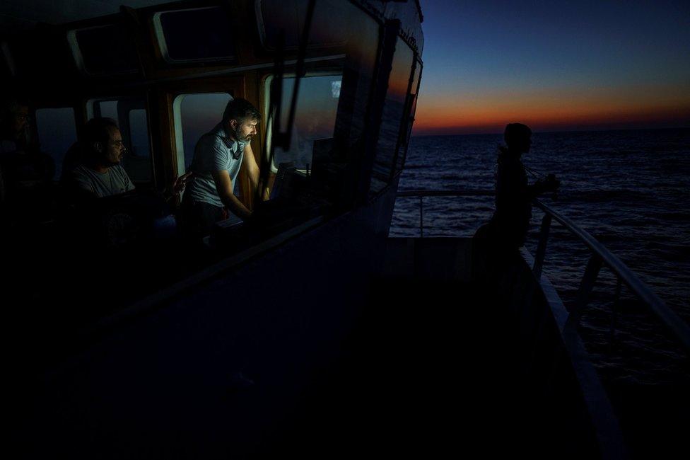 Head mission of NGO Proactiva Open Arms Riccardo Gatti tracks the position of a rubber boat in central Mediterranean Sea