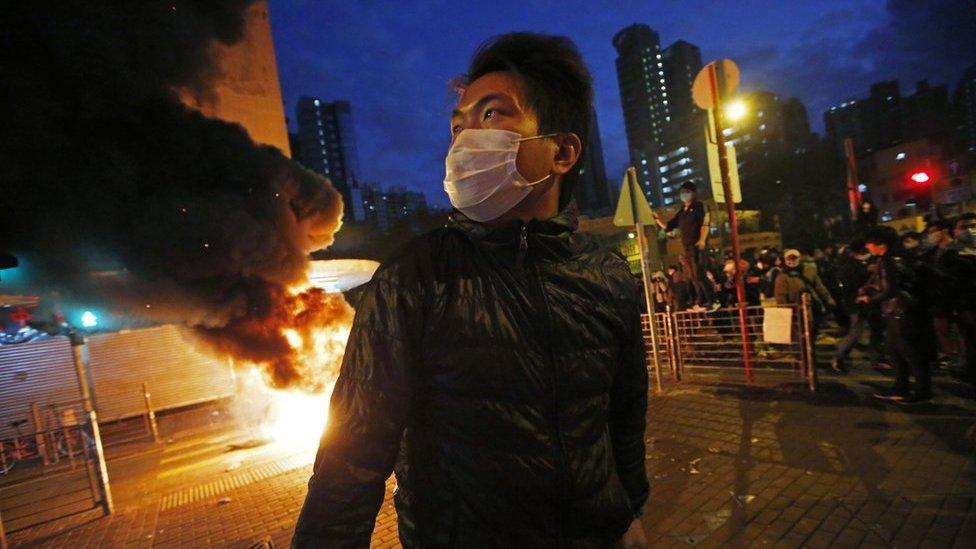 Smoke rises as protestors set fires on a street in Mong Kok district of Hong Kong, Tuesday, 9 February 2016.