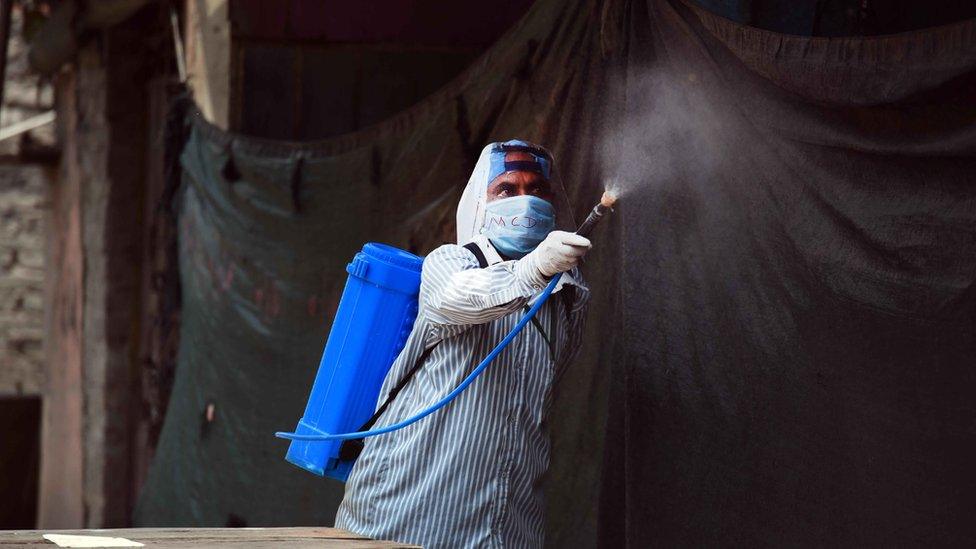 A man disinfecting a neighbourhood