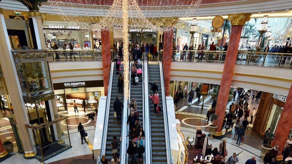 Shoppers on the escalator at Trafford centre