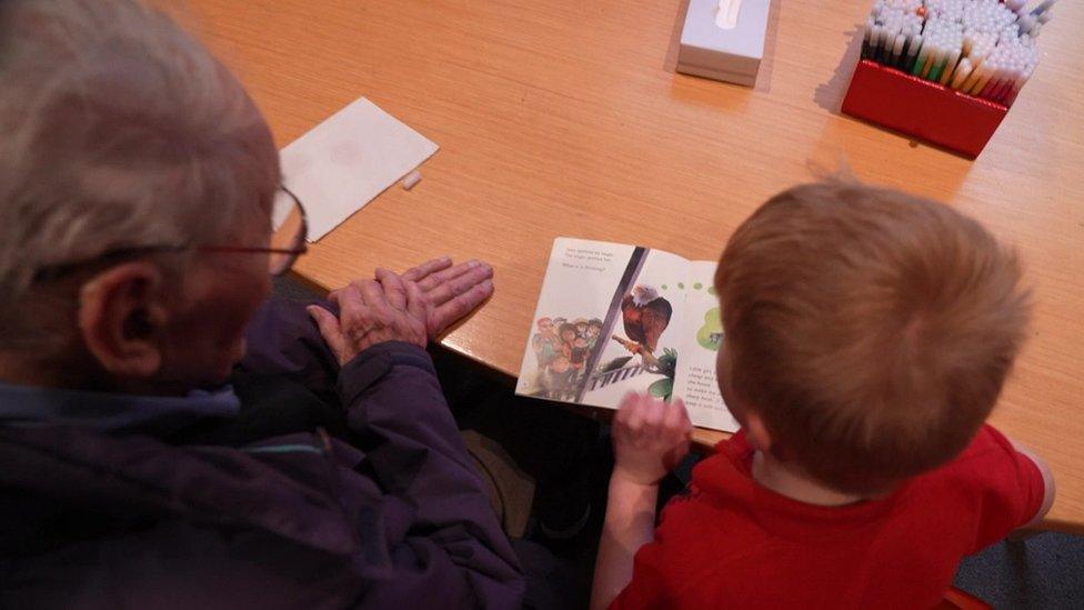 Peter Davies reading with a school pupil