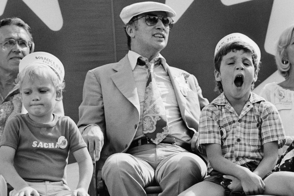 Justin Trudeau (right, yawning) grew up in a political family - his father Pierre (centre) was also PM