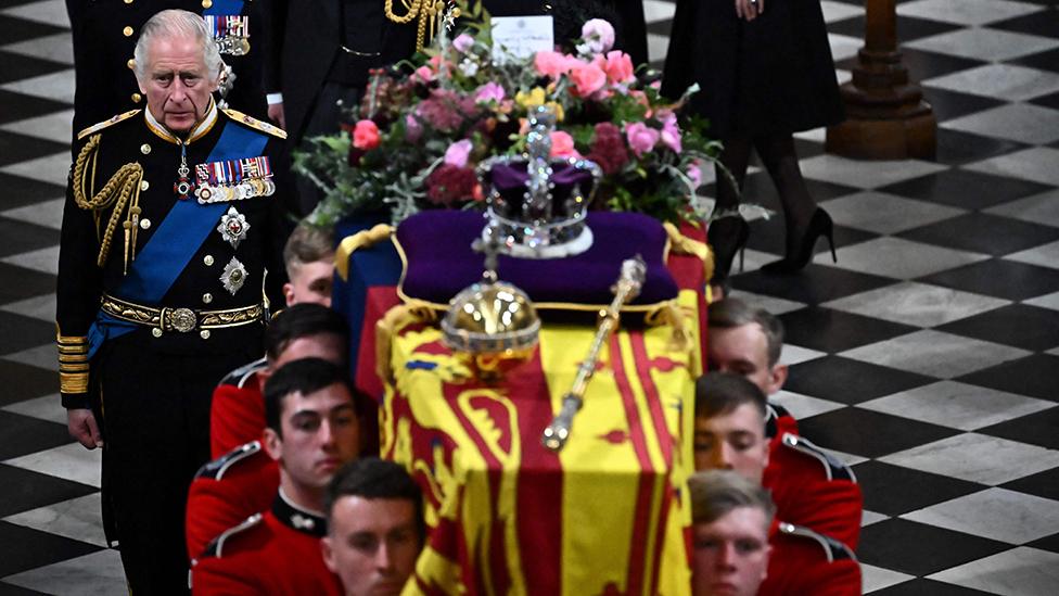 King Charles III walks behind the coffin of Queen Elizabeth II as they leave Westminster Abbey in London on September 19, 2022