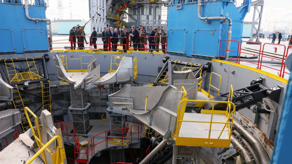 The delegations examine a rocket launchpad