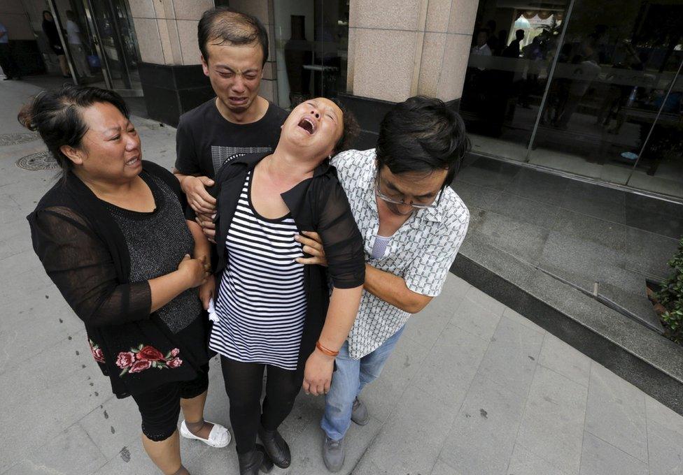 Relatives of a missing firefighter outside the venue of a news conference in Tianjin, China, on August 15, 2015