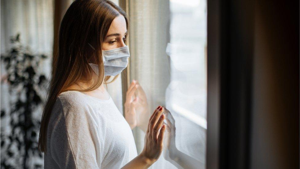 woman looking out of window