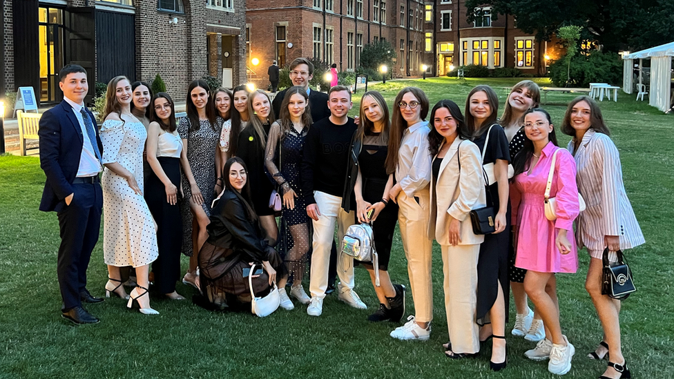 A group of 21 Ukrainian medical students standing outside a Cambridge University building