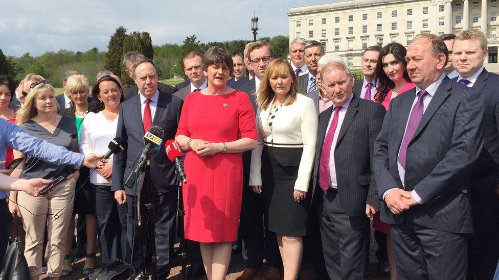 DUP leader Arlene Foster and her party colleagues speak to the media outside Parliament Buildings at Stormont