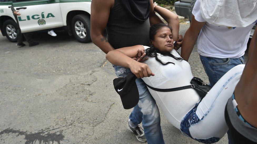 A demonstrator affected by tear gas is carried out from the Simon Bolivar international bridge, in Cucuta, Colombia,