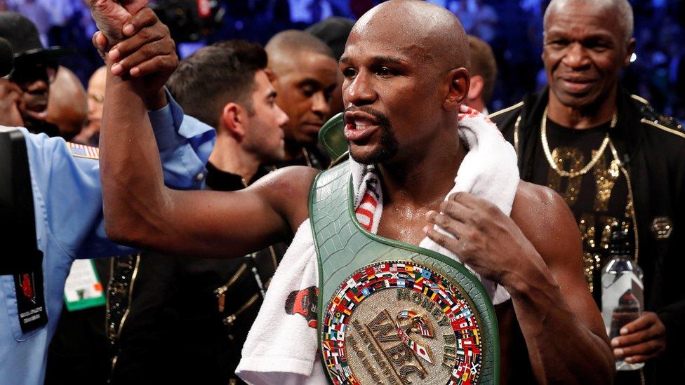 Floyd Mayweather Jr. celebrates with the belt after winning the fight against Conor McGregor (not shown) in Las Vegas, Nevada, U.S. on 26 August 2017.