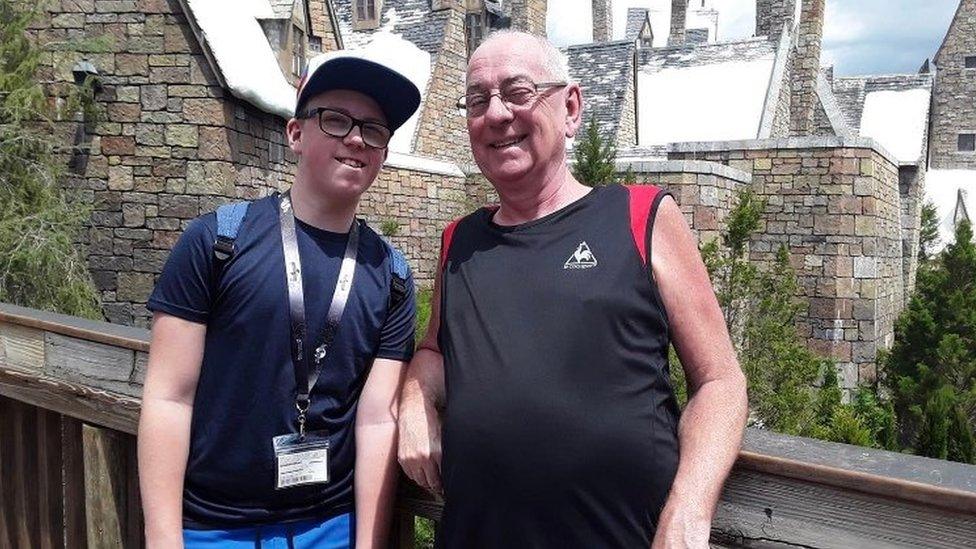 picture of a Gareth and a boy, Zac posing in front of a heritage building