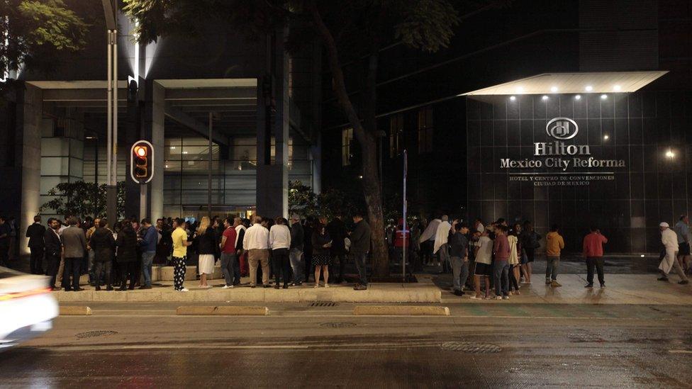 People standing outside hotel