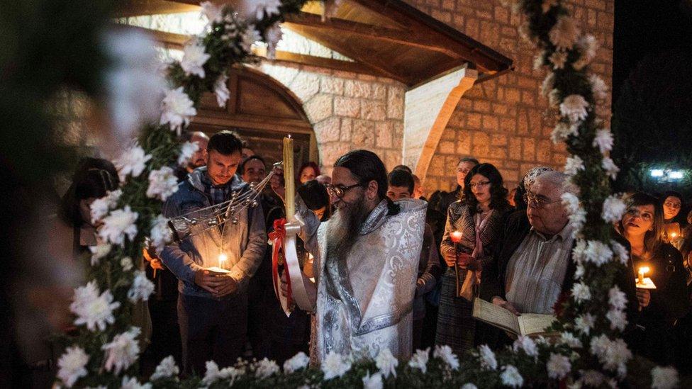 A North Macedonian Orthodox priest leads a midnight Easter service in the village of Kalishta