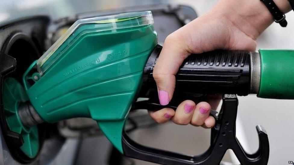 Woman filling her car with petrol