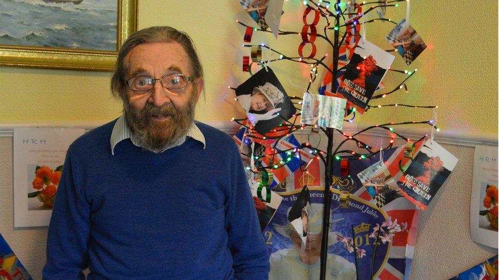 Frank Ward with a tree decorated to celebrate the Queen's birthday