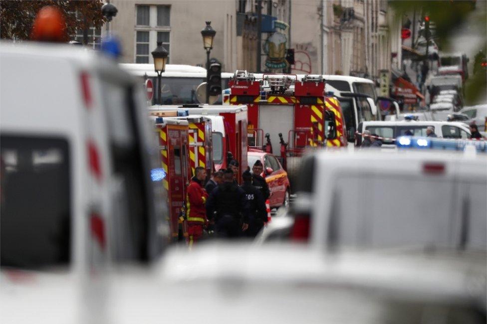 French police and security forces establish a security perimeter near the police headquarters in Paris.