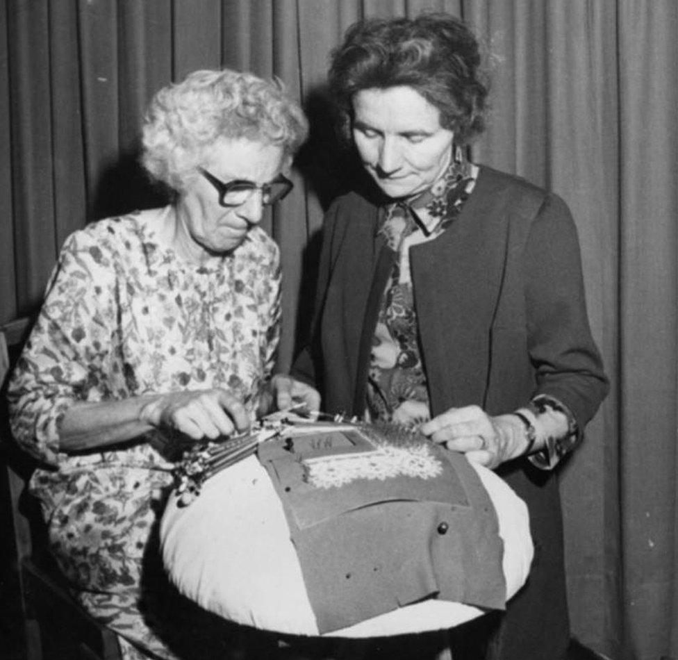 Eunice Arnold, kneeling next to her student, Kathleen Booth