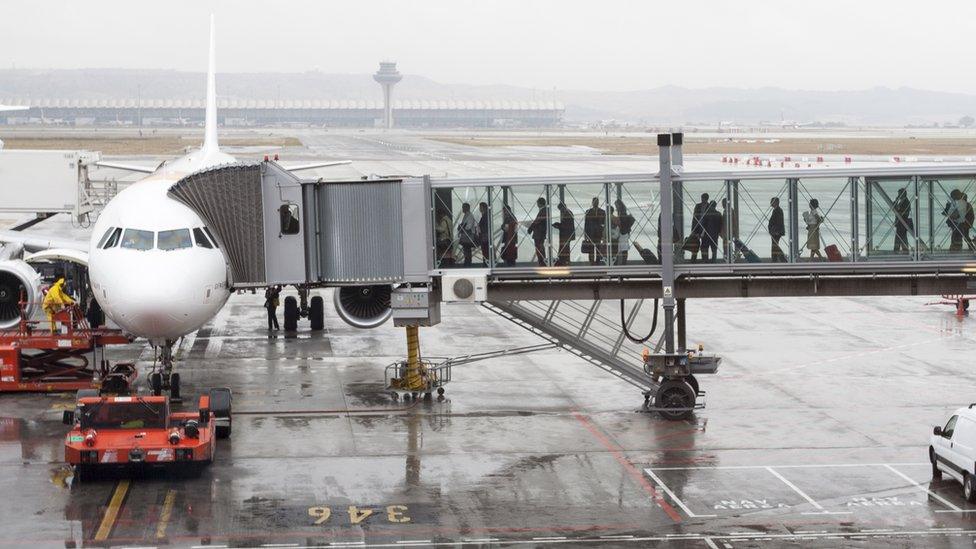 Passengers boarding a plane at Madrid Barajas Airport