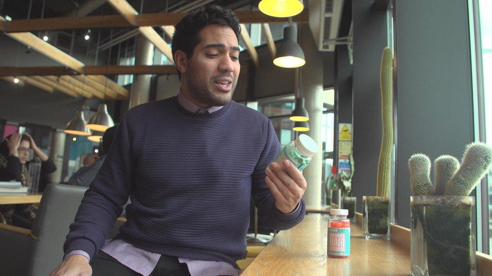 Presenter holding jar of the chewable hair vitamins