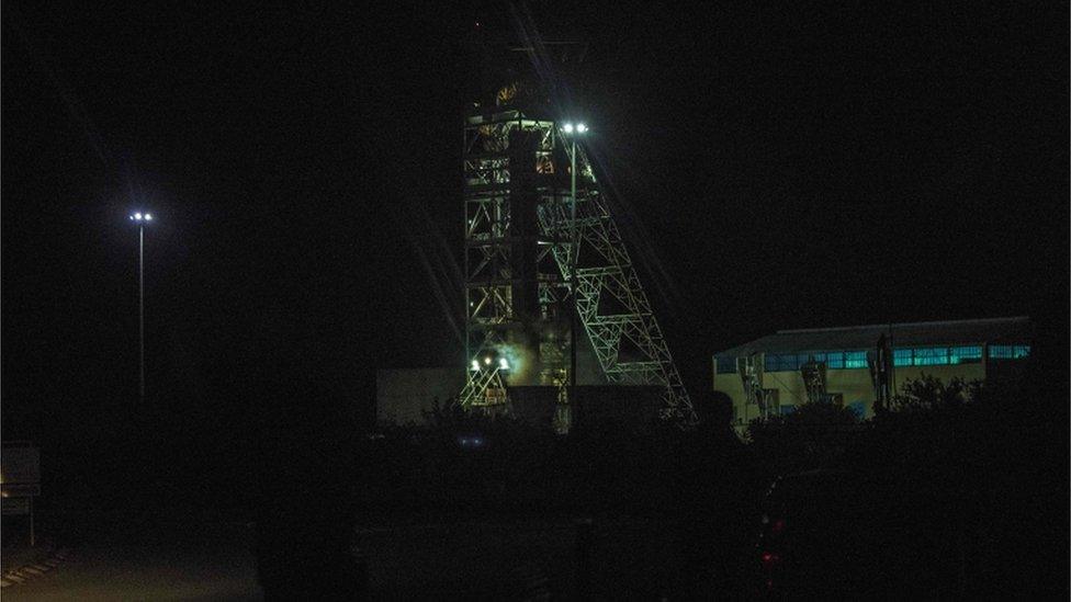 Photograph taken in the dark shows the mineshaft of the mine where men are trapped