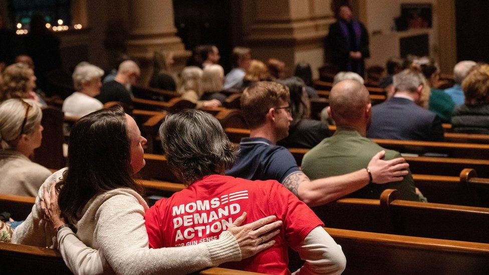 People gather at Belmont United Methodist Church during a vigil for the shooting victims