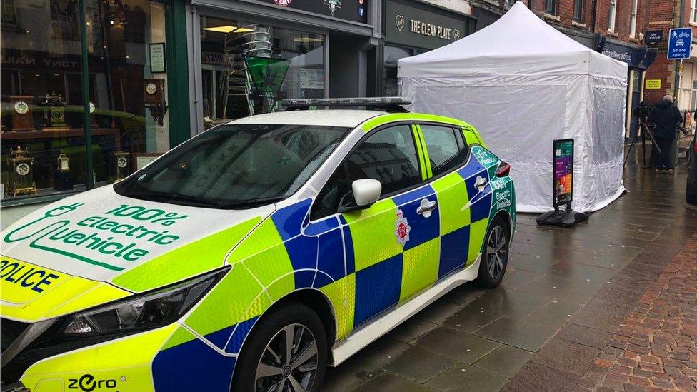 Police car outside cafe