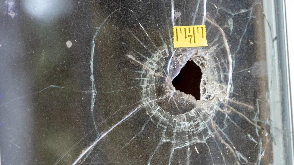 Bullet holes are seen in the glass at the Murdaugh Moselle property