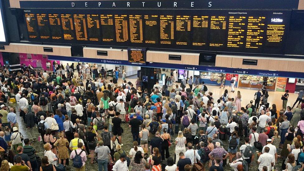 passengers at Euston station in London following train cancellations