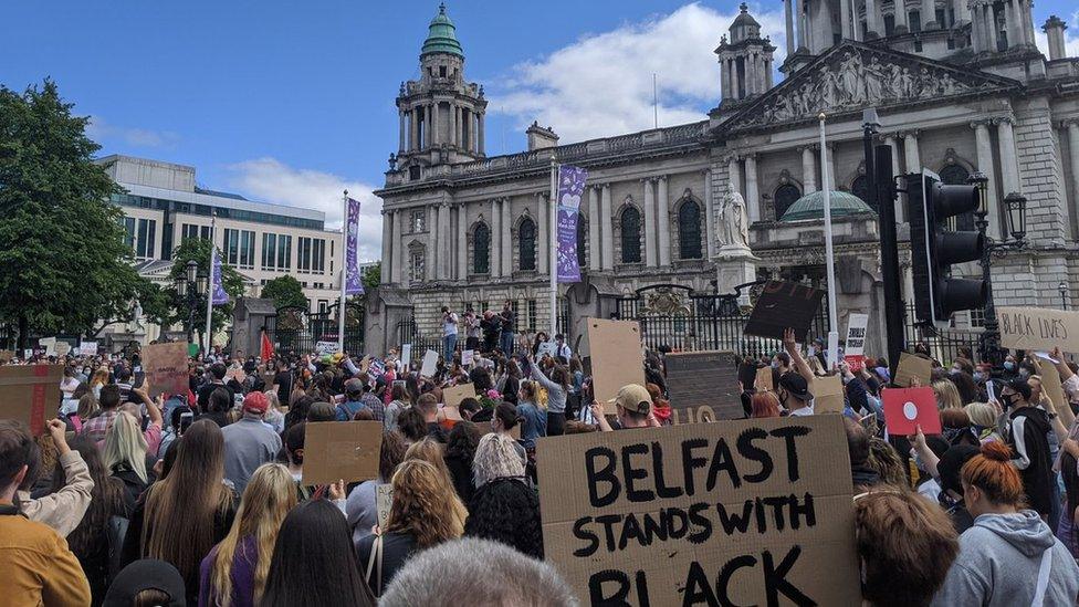 A large crowd has gathered at Belfast City Hall to protest over the death of George Floyd