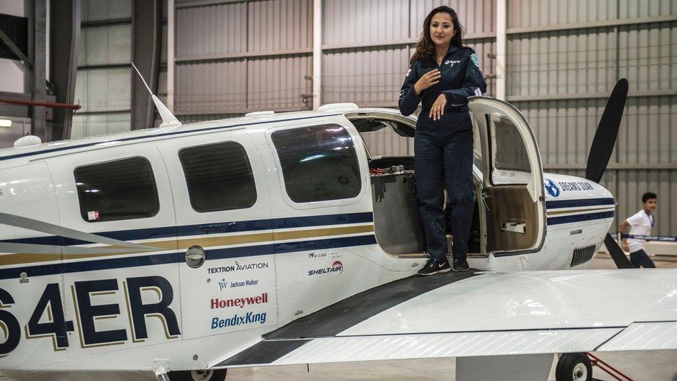 Shaesta Waiz, Afghanistan's first female certified civilian pilot, poses for a picture on her plane at Cairo International Airport on July 2, 2017