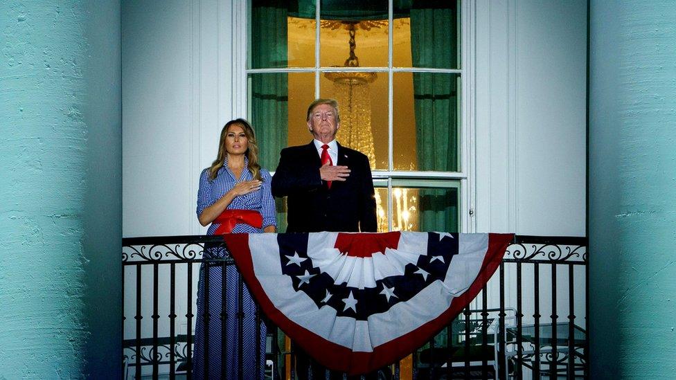 US President and First Lady have hand on hearts listening to national anthem on White House balcony