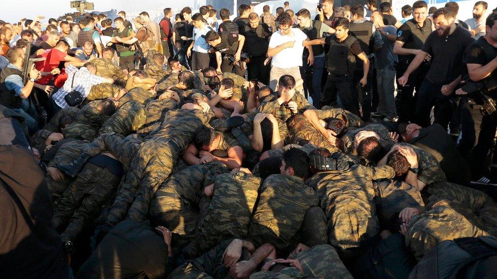 Surrendered Turkish soldiers who were involved in the coup are surrounded by people on Bosphorus bridge in Istanbul, Turkey, July 16, 2016